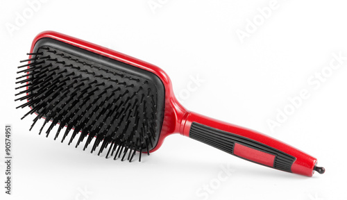 Red comb the hair on a white background