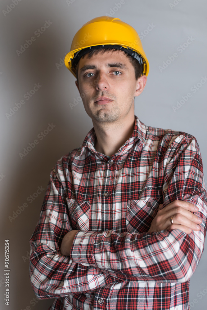 young man in a construction helmet, builder young man in a construction helmet, builder