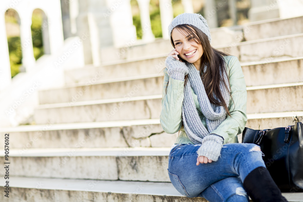 Young woman sitting on the stairs outdoor
