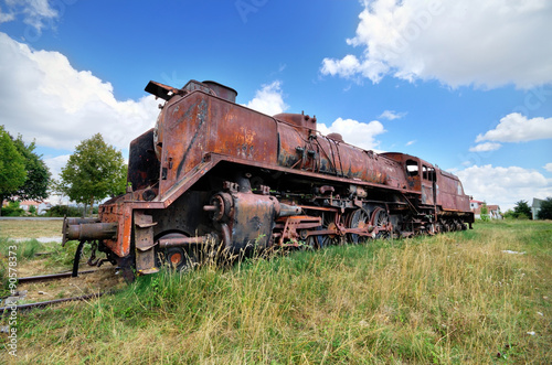 Scenic HDR image of an old ruined locomotive.