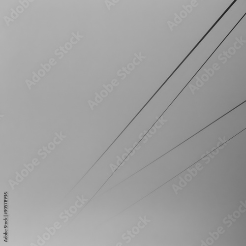 Minimalistic black and white image of cable way dissolving in a
