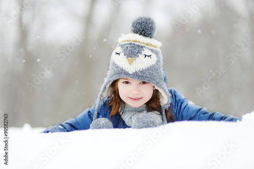 Funny little girl having fun in winter park © MNStudio