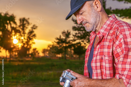 Senior photographer enjoy in nature. photo