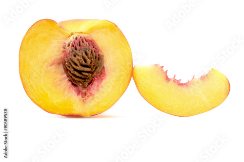 cut in half with a slice of peach close-up isolated on white background