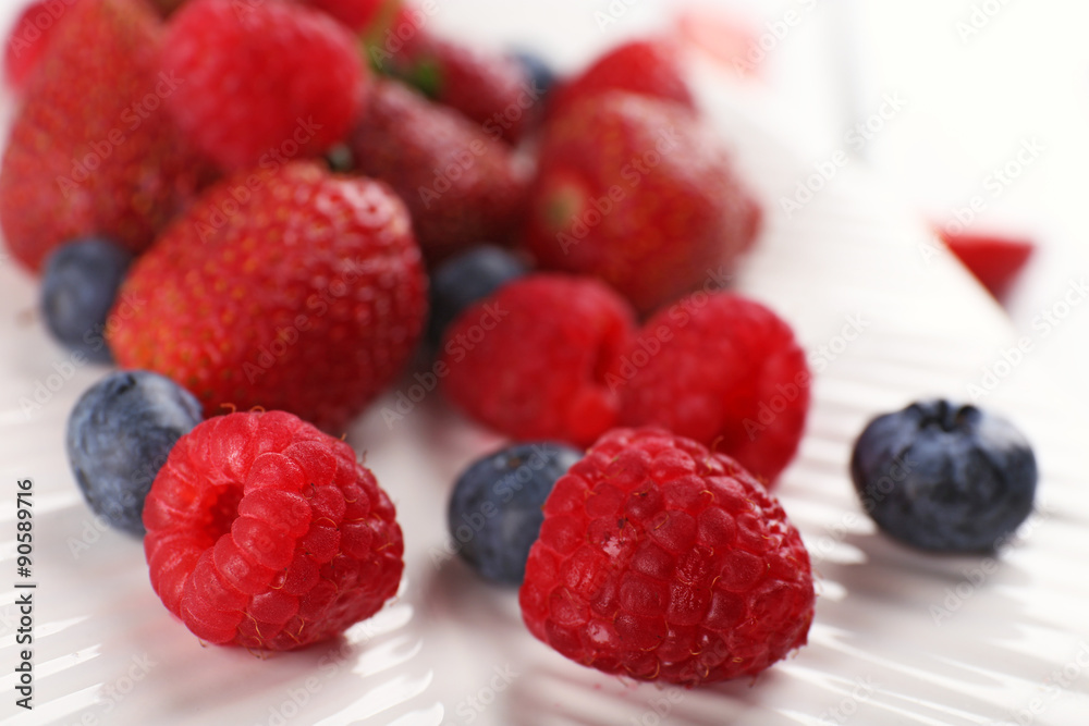 Tasty ripe berries on plate close up Tasty ripe berries on plate close up