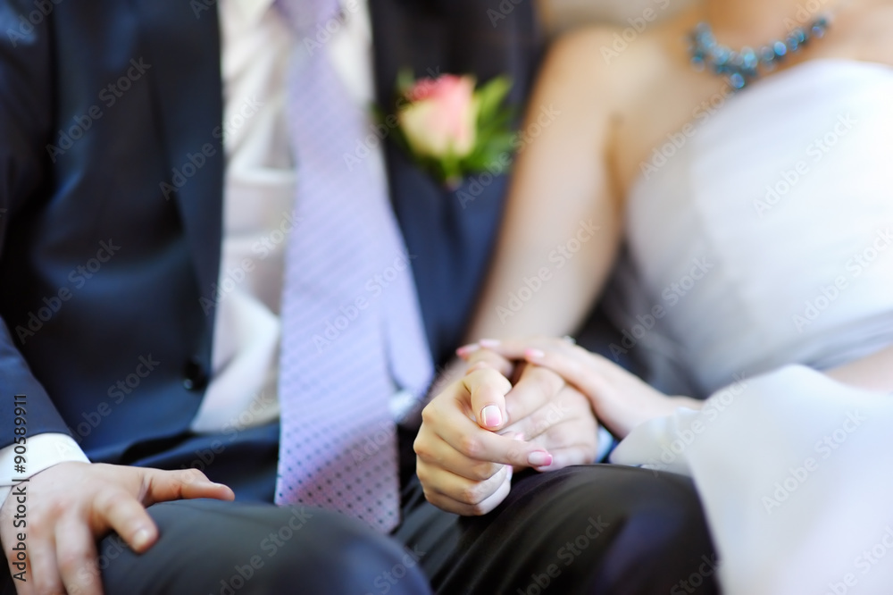 Fototapeta premium Bride and groom holding hands