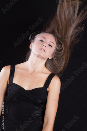 Pretty woman with long hair, slinging her hair