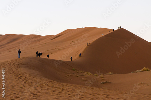 Climbing the red sand dunes at Sossousvlei at dawn to watch the sunrise.This is the lower ridge of Dune 24. 