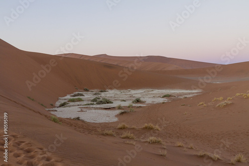 Sunrise over the dunes at Sossousvlei, looking down at a clay pan. 