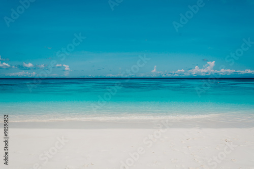 blue sky with sea and beach - soft focus with film filter © topntp