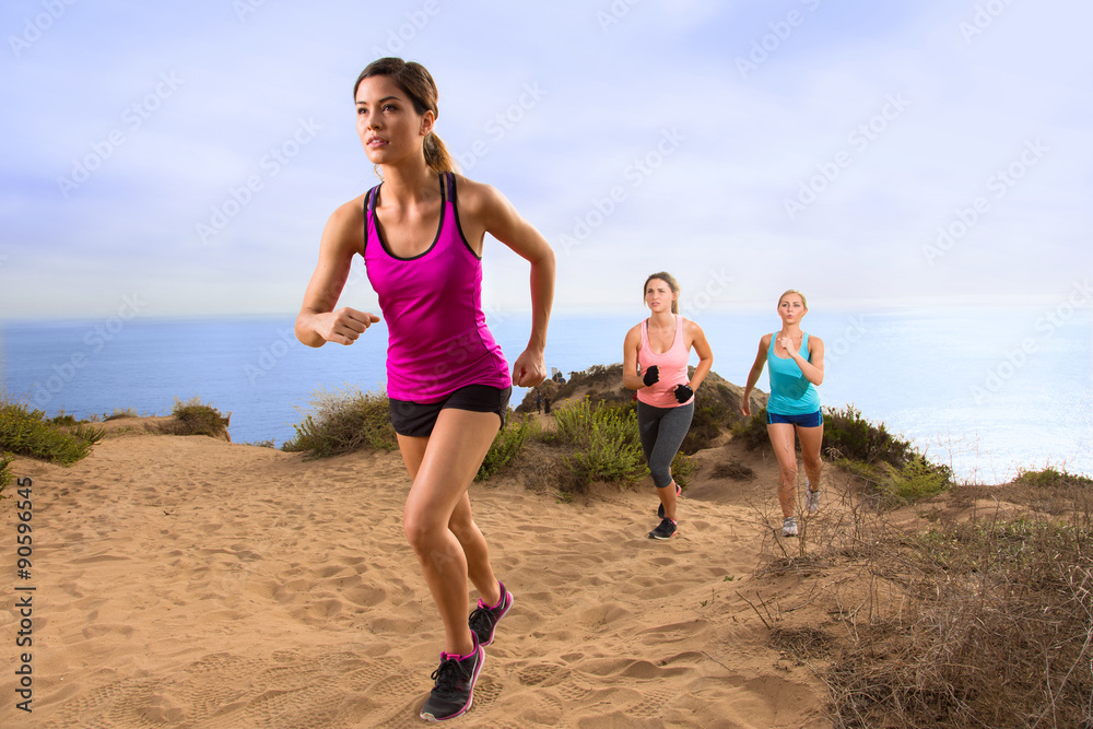 Runners jogging on hike on mountain trail path outdoors in sportswear cross country endurance training Runners jogging on hike on mountain trail path outdoors in sportswear cross country endurance training