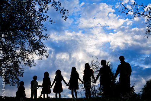 Family silhoutte holding hands showing family bond 