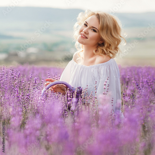 Beautiful woman in a field of blossoming lavender
