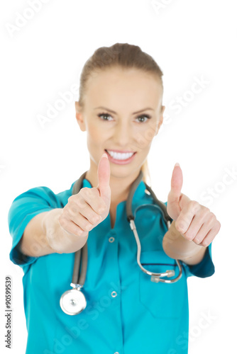 Woman doctor with thumbs up.