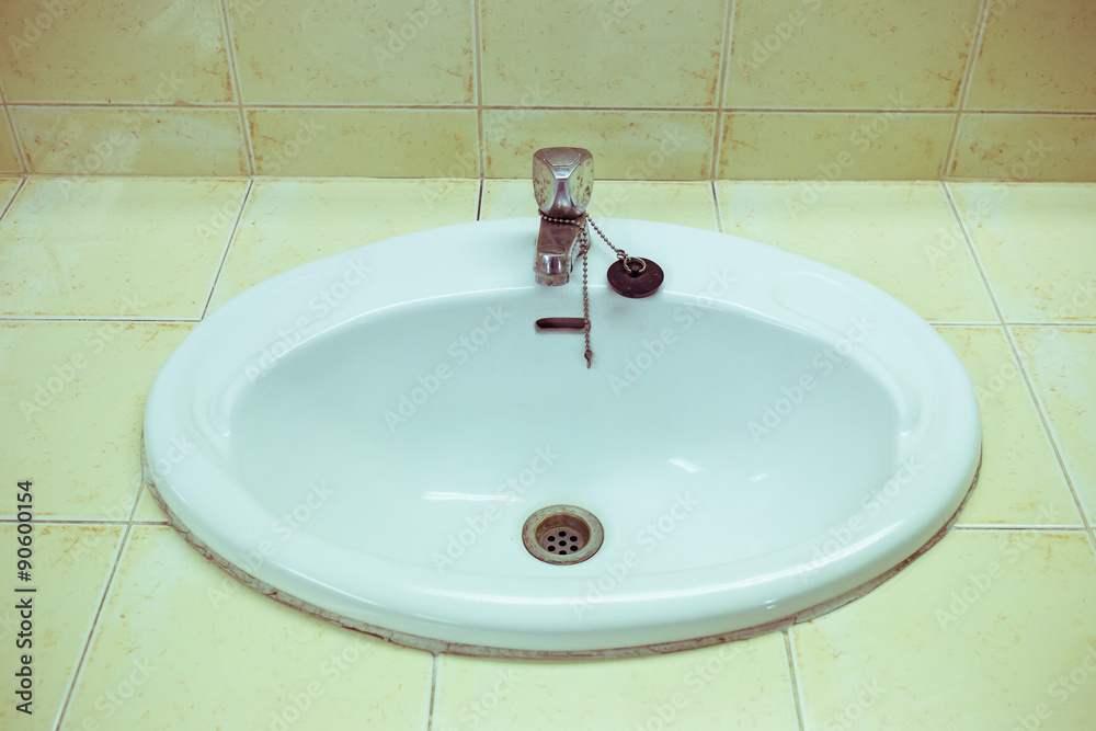 Fototapeta premium white wash sink in the bathroom with old silver faucet