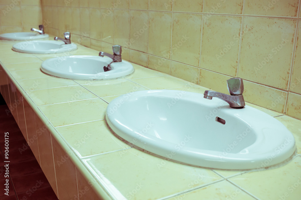 Fototapeta premium white wash sink in the bathroom with old silver faucet