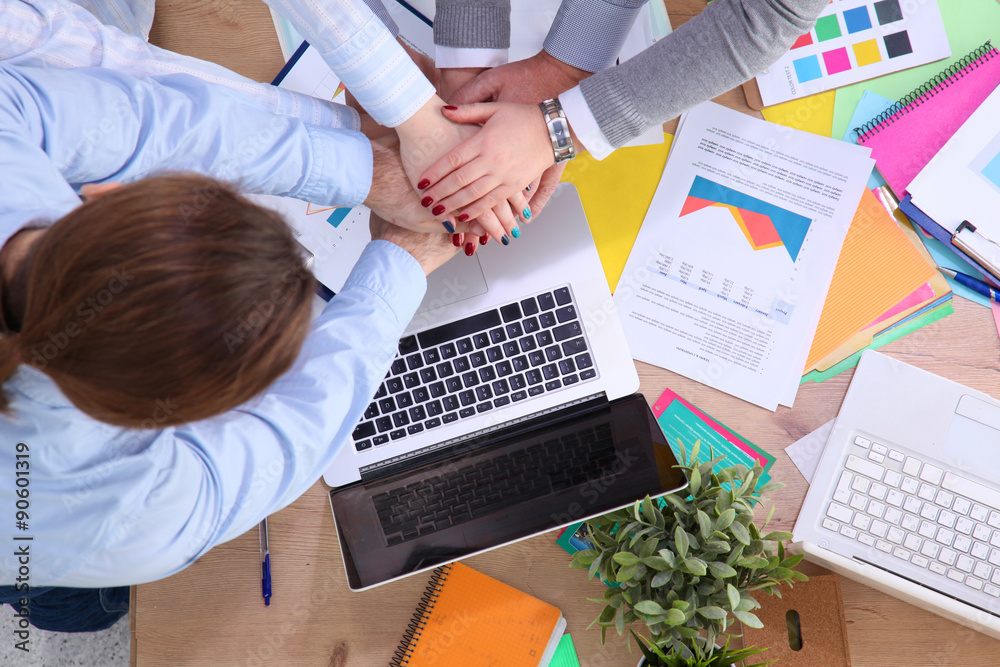 Image of business partners discussing documents and ideas at
