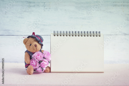 Teddy bear holding flower with blank card  © sirirak
