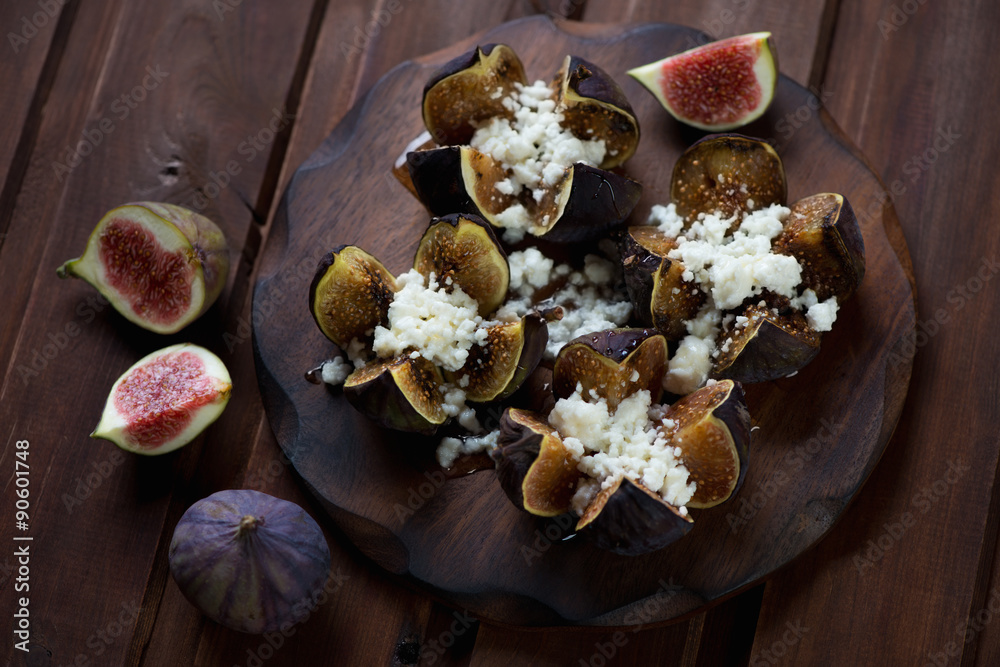 Baked figs with cottage cheese and honey, dark wooden background