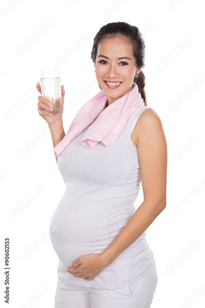 Beautiful pregnant asian woman holding a glass water, smiling at Beautiful pregnant asian woman holding a glass water, smiling at