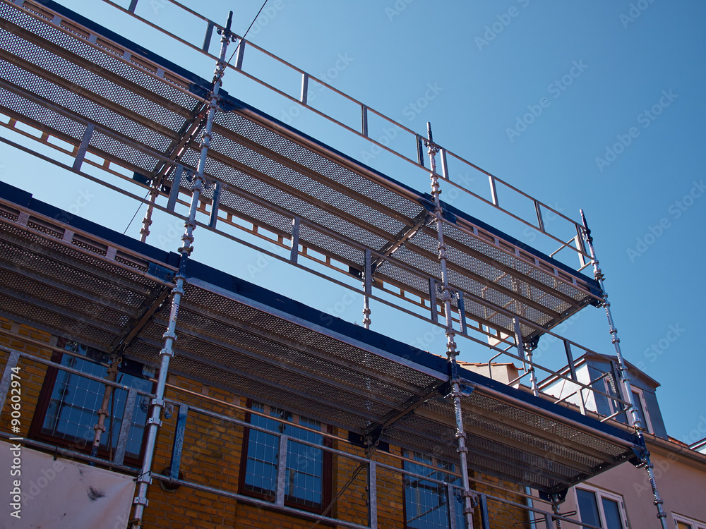 Scaffolds on a house building under renovations Scaffolds on a house building under renovations