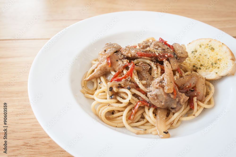 Spaghetti, spicy chicken.on wood table