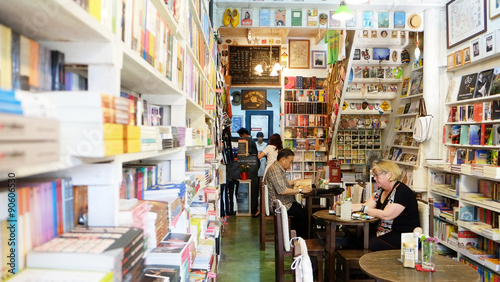 Tourist is in a bookshop, Thailand reading a book 