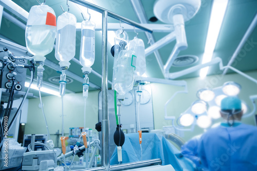 Obraz na płótnie IV bags and bottles hanging on poles during a real surgery w salonie