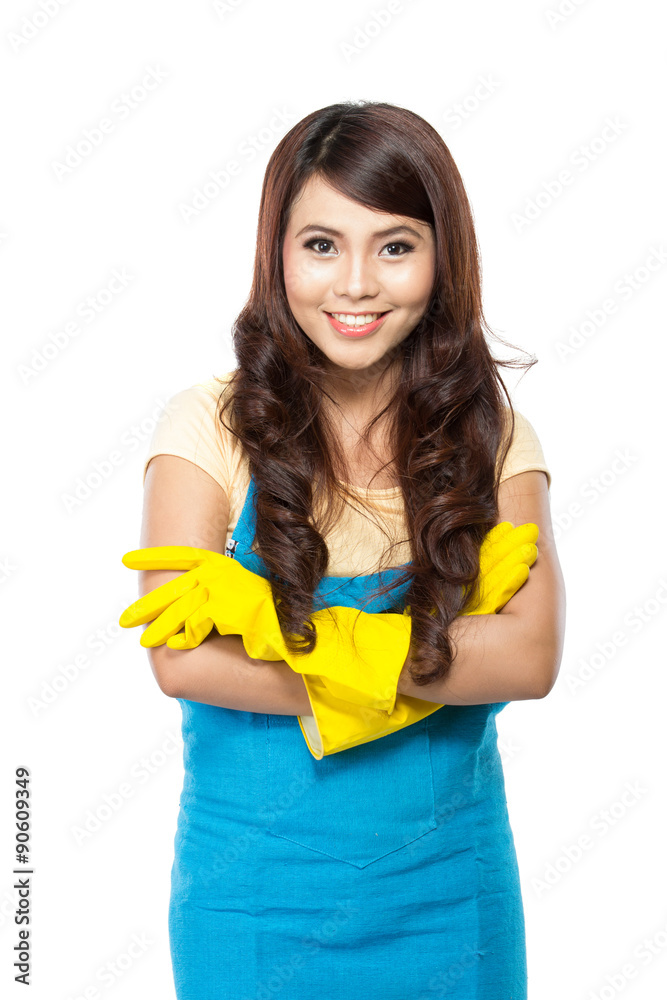 Young asian woman getting ready to do the chores, putting on yel Young asian woman getting ready to do the chores, putting on yel