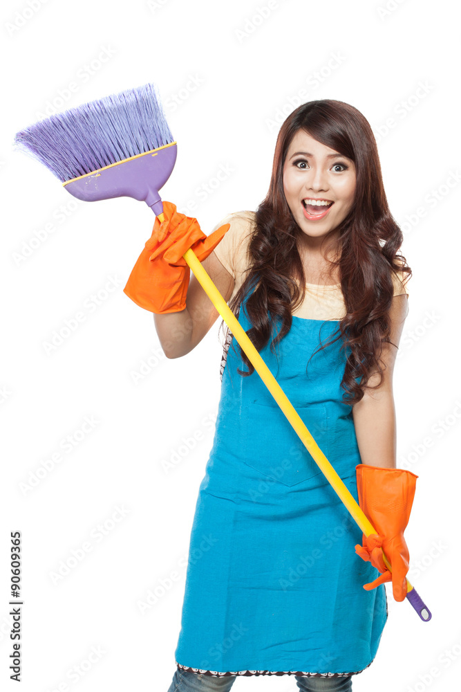 Beautiful young asian woman posing hold onto a broom, while smil Beautiful young asian woman posing hold onto a broom, while smil