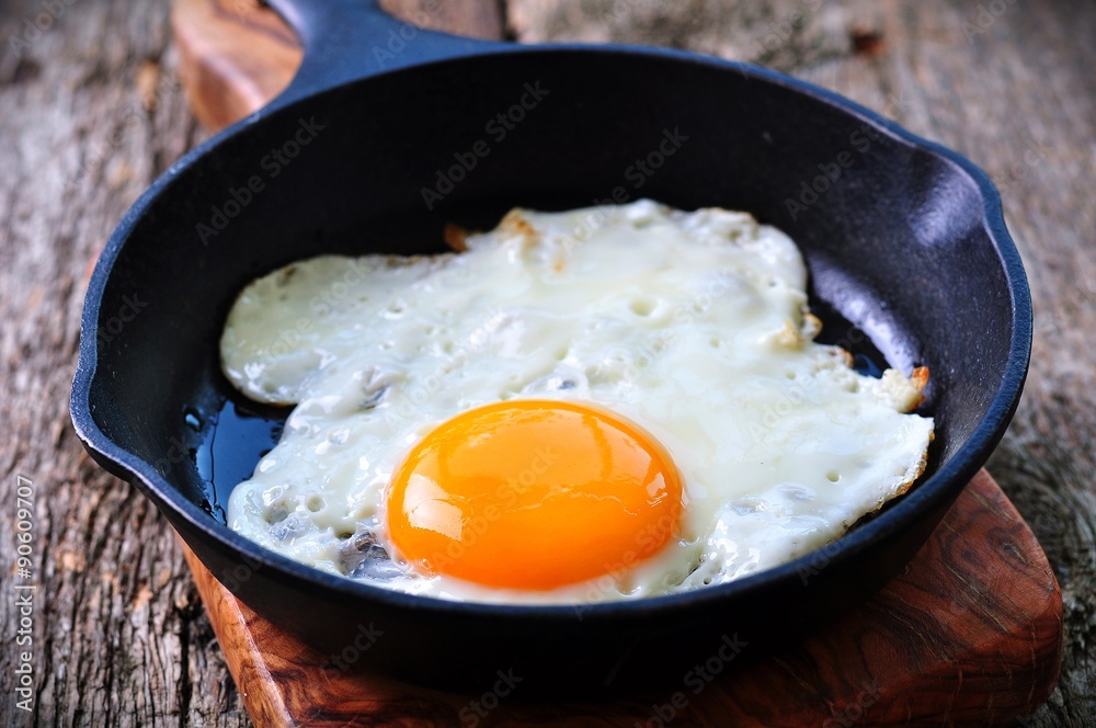 Breakfast the fried egg in a iron frying pan Breakfast the fried egg in a iron frying pan