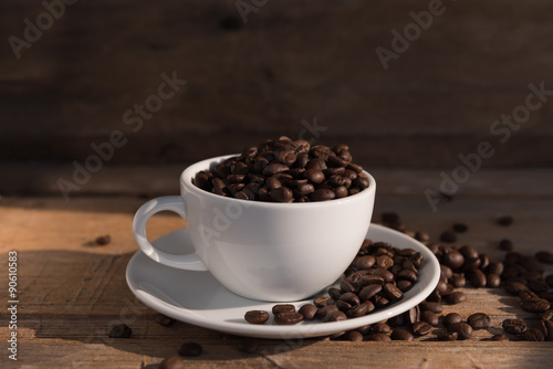 Still life coffee cup and roasted beans on old wood background