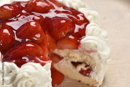 Fresh strawberry cake on wood plate