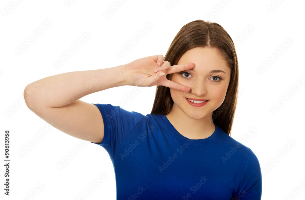 Happy teenager with victory sign on eye. Happy teenager with victory sign on eye.