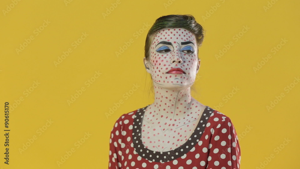 Girl made up as a girl from a comic book posing on a bright Girl made up as a girl from a comic book posing on a bright