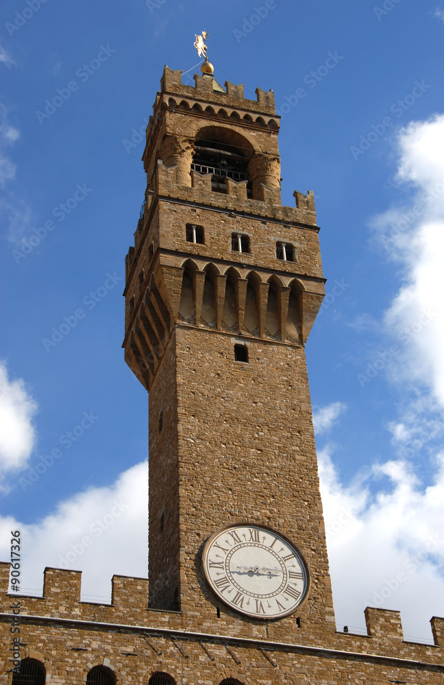 Palazzo vecchio tower in Florence with blue sky and clouds