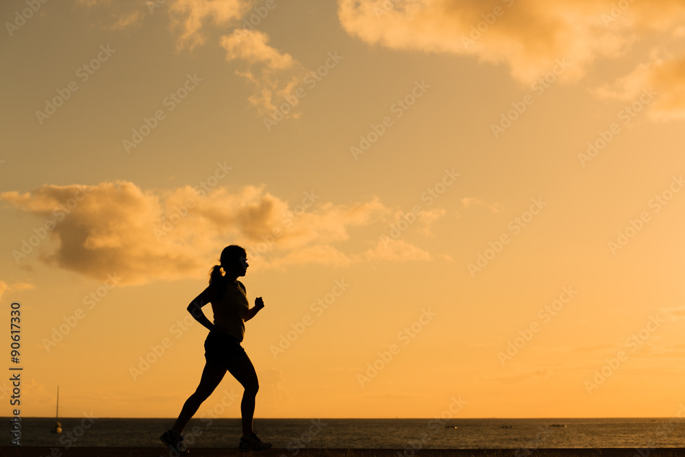 Silhouette running women at sunset Silhouette running women at sunset