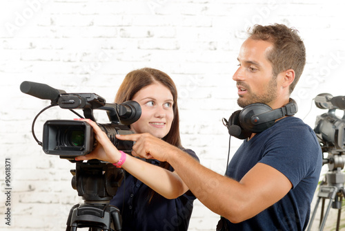 young cameraman and a pretty young woman photo