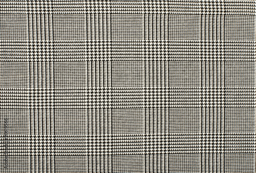 Black and white houndstooth pattern in squares. Black and white wool twill pattern. Woven dogstooth check design as background.
