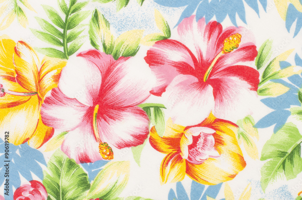 Floral pattern on fabric. Yellow and pink big flower with green and blue leaves print as background.