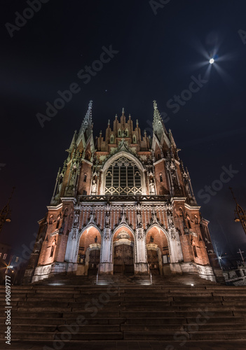 Gothic church with fabulous facade during the night, with the Moon in the sky #90619777