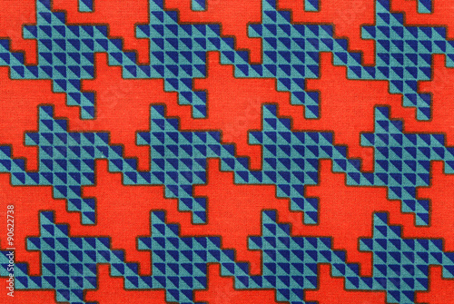 Orange and blue houndstooth pattern. Closeup on big dogstooth check design as background.