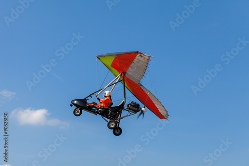 The motorized hang glider in the blue sky