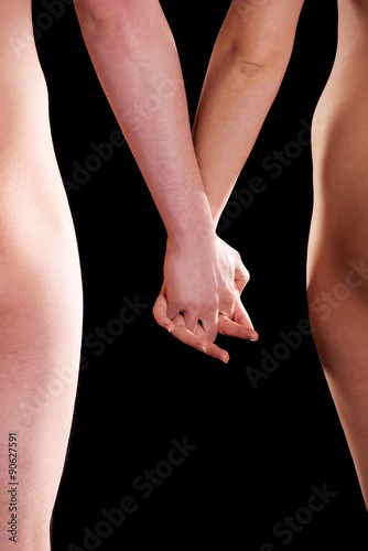 Naked couple holding their hands. © Piotr Marcinski
