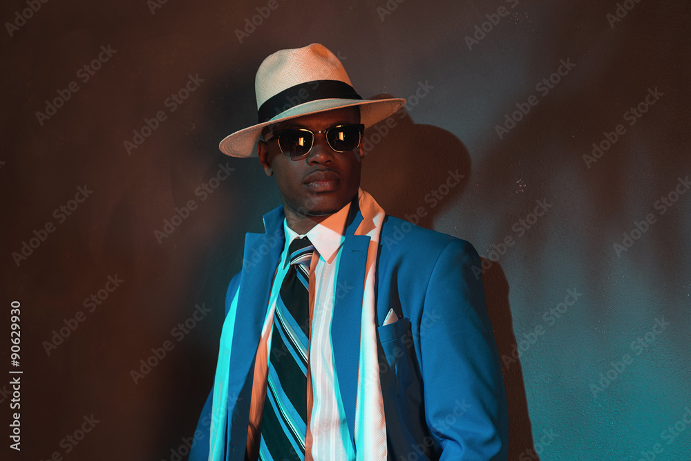African american retro man in blue suit wearing straw hat and su