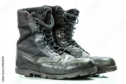 Black old combat military boots isolated on white background