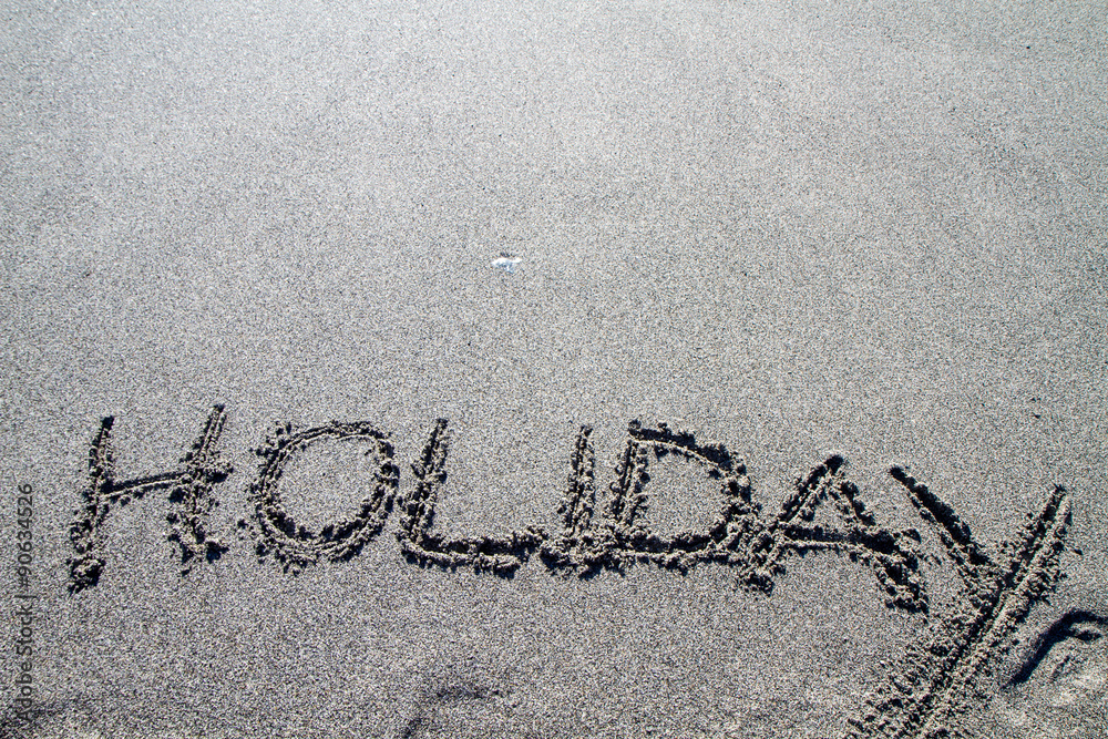 Fototapeta premium words written on the pebble beach, holiday