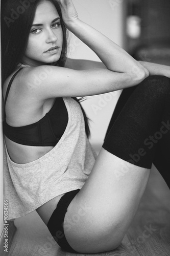 beautiful young girl posing sitting on the floor