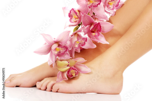 Woman legs with pink flowers.