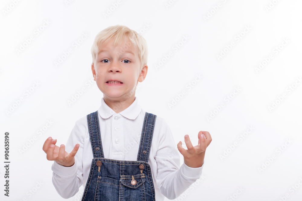 Cheerful small boy is expressing his negative emotions Cheerful small boy is expressing his negative emotions